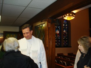 Greeting worshippers after service.